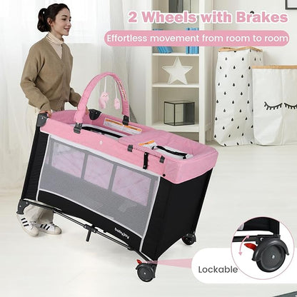 BABY JOY 3 in 1 Pink Pack and Play, Travel Baby Crib Bassinet Bed with Bassinet for Girl, Changing Table w/Safety Belt, Toy Bar, Lockable Wheels, Portable Baby Playard from Newborn to Toddler