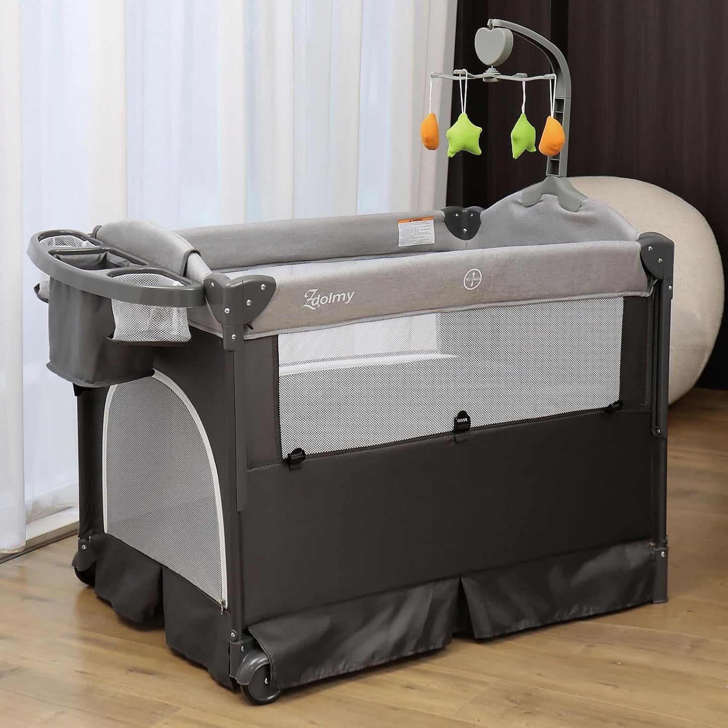 Zdolmy Baby Bedside Sleeper Bassinet, 4-in-1 Pack and Play with Bassinet w/Diaper Changing Table & Storage Bag, 3 Adjustable Heights, Toy Arch & Music, Portable Baby Play Yard with Carry Bag