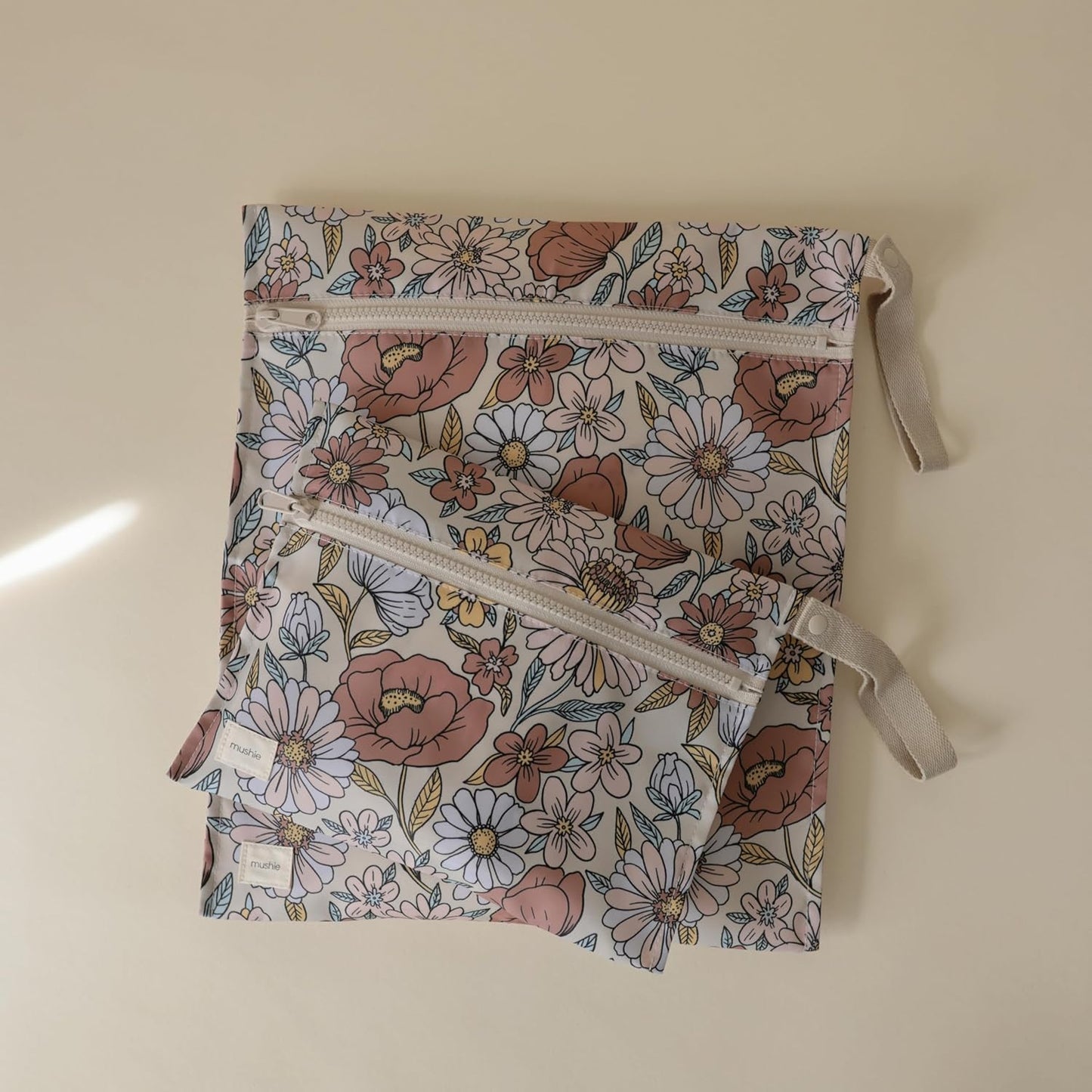 mushie Water Resistant Wet Bags | Large & Small Reusable Storage Bag for Baby Items and Travel | Zippered Pockets with Handle | Machine Washable, Set of 2 (Pastel Blooms)