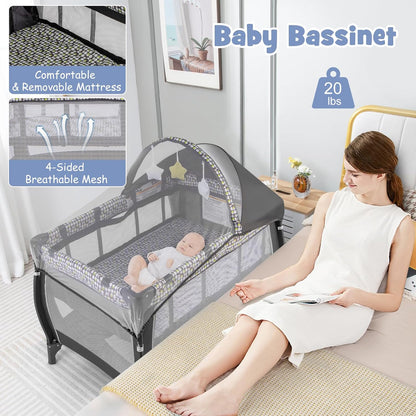 HONEY JOY Pack and Play with Bassinet, 4-in-1 Portable Baby Playard with Changing Table, Net & Cute Toys, Diaper Storage Bag, Music Box, Wheels with Brake, Foldable Newborn Play Yard w/Carry Bag