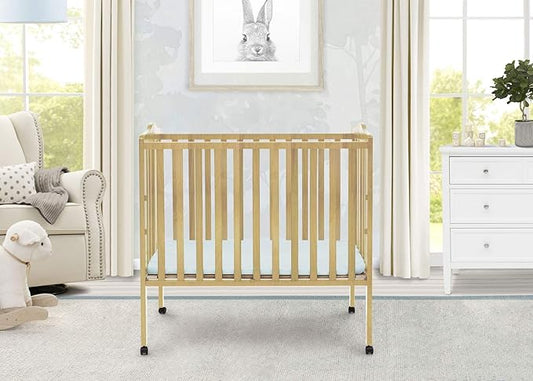 Delta Children Folding Portable Mini Baby Crib with 1.5-inch Mattress - Greenguard Gold Certified, Natural