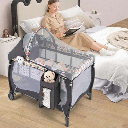 HONEY JOY Pack and Play with Bassinet, 4-in-1 Portable Baby Playard with Changing Table, Net & Cute Toys, Diaper Storage Bag, Music Box, Wheels with Brake, Foldable Newborn Play Yard w/Carry Bag